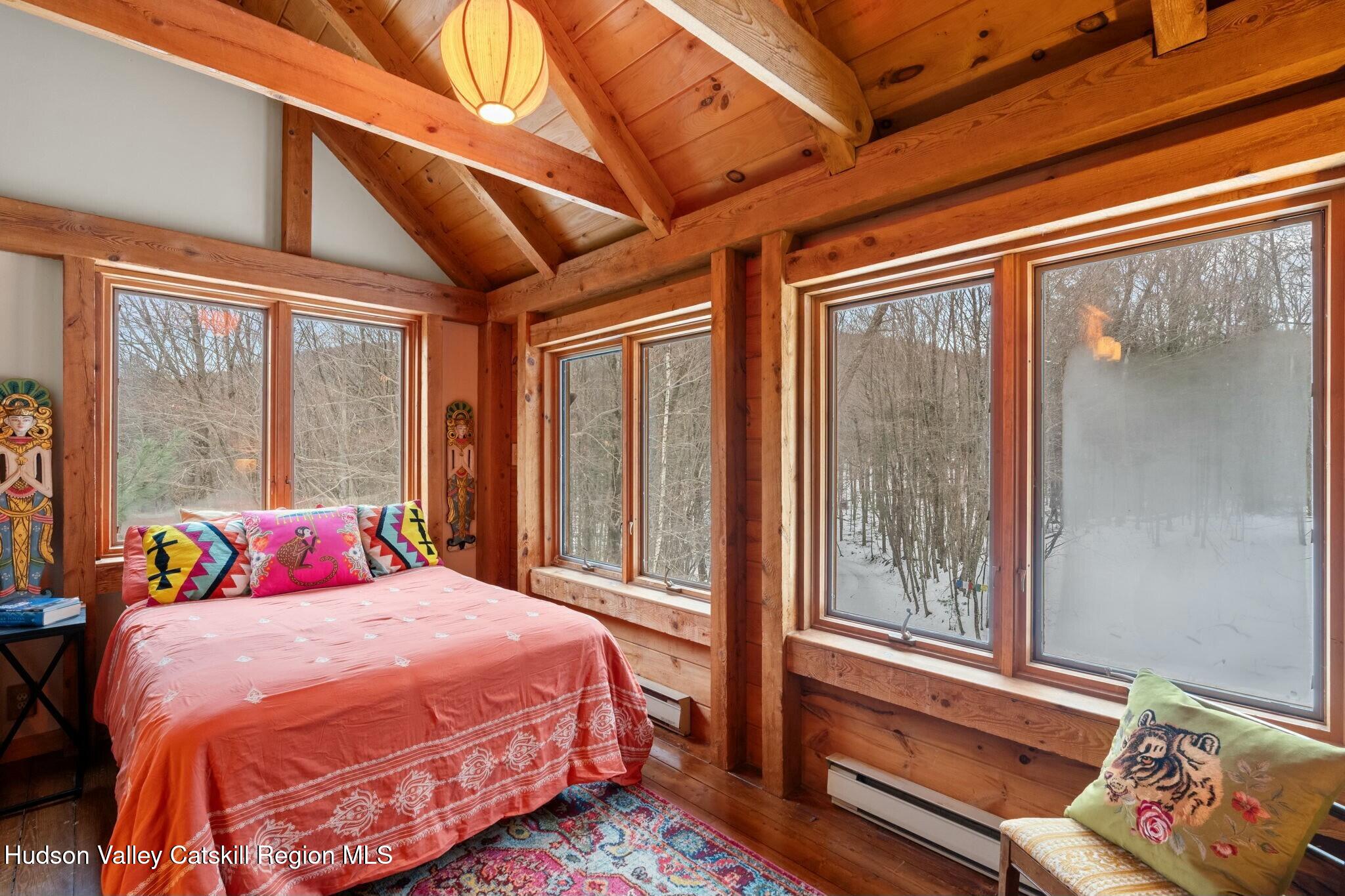 250 Macdaniel Road Woodstock, NY 12498 - Photo 19 of 39 a bedroom with a bed and a large window with outer view