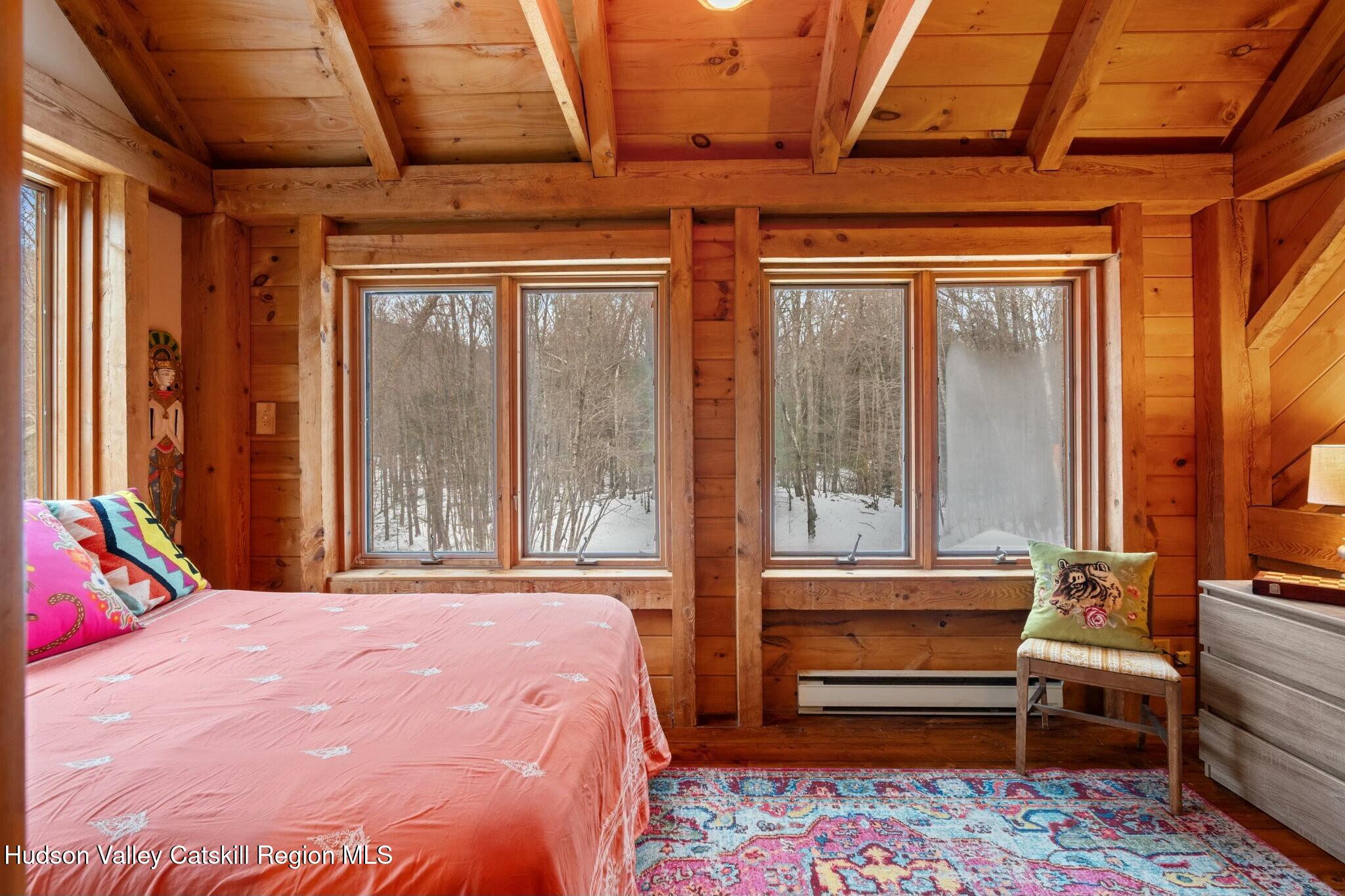 250 Macdaniel Road Woodstock, NY 12498 - Photo 21 of 39 a bedroom with a bed next to a large window