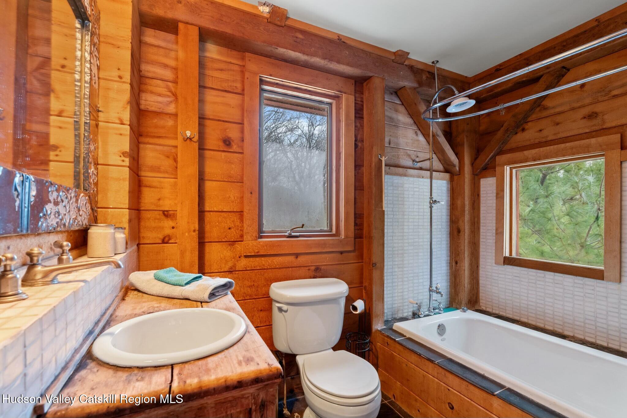 250 Macdaniel Road Woodstock, NY 12498 - Photo 26 of 39 a bathroom with a sink toilet mirror and tub