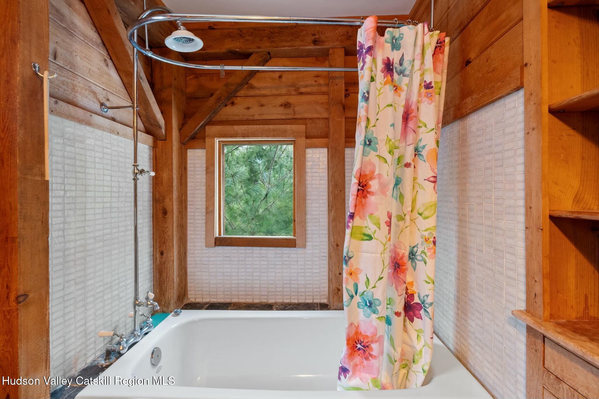 250 Macdaniel Road Woodstock, NY 12498 - Photo 27 of 39 a bathroom with a bathtub and shower