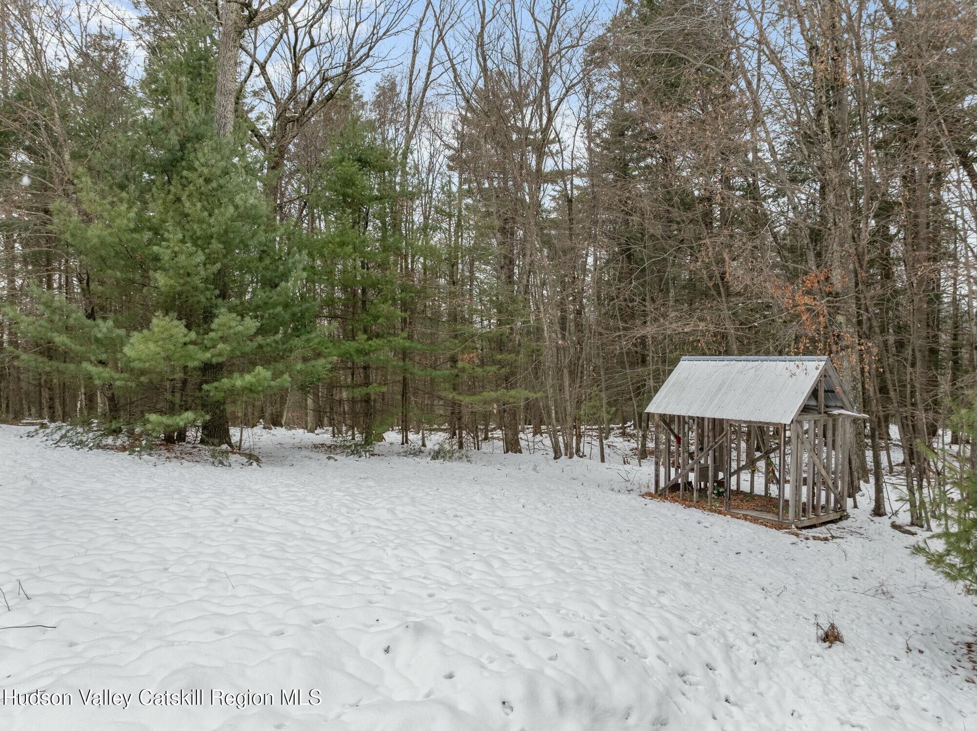250 Macdaniel Road Woodstock, NY 12498 - Photo 32 of 39 a view of a bench under a large tree
