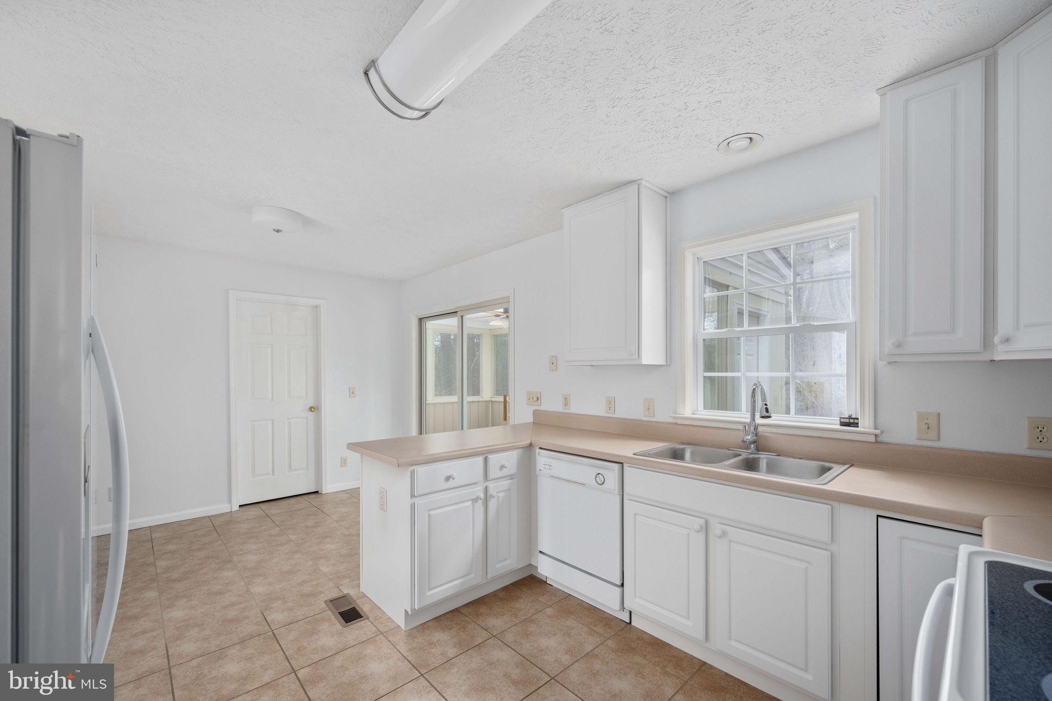 67 Stern Way Montross, VA 22520 - Photo 21 of 74 a kitchen with a sink cabinets and window