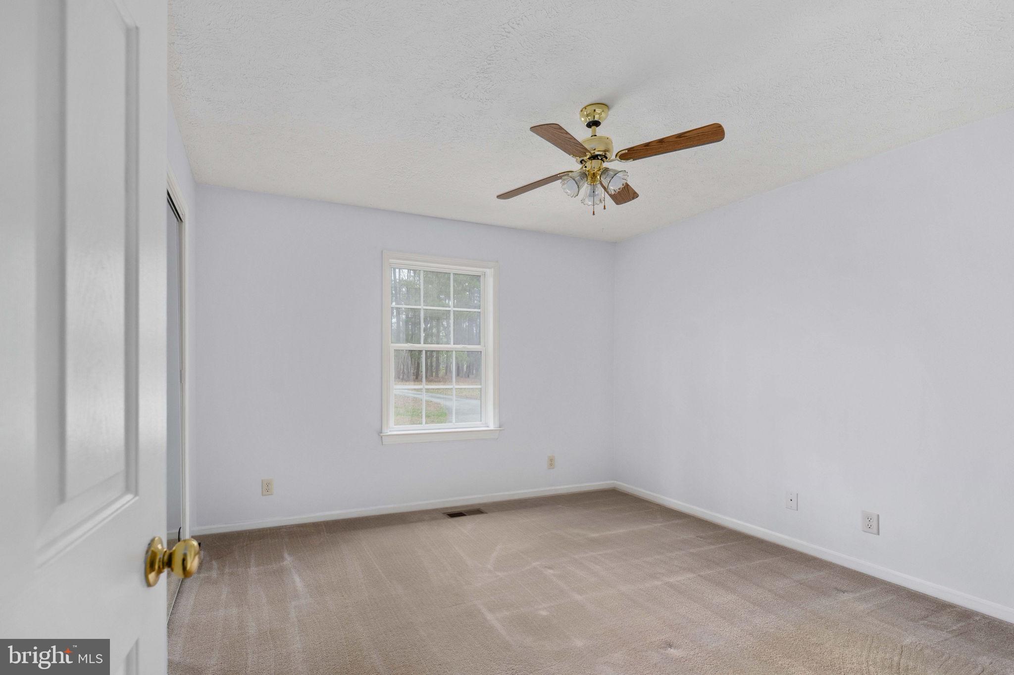 67 Stern Way Montross, VA 22520 - Photo 31 of 74 an empty room with a window and a fan