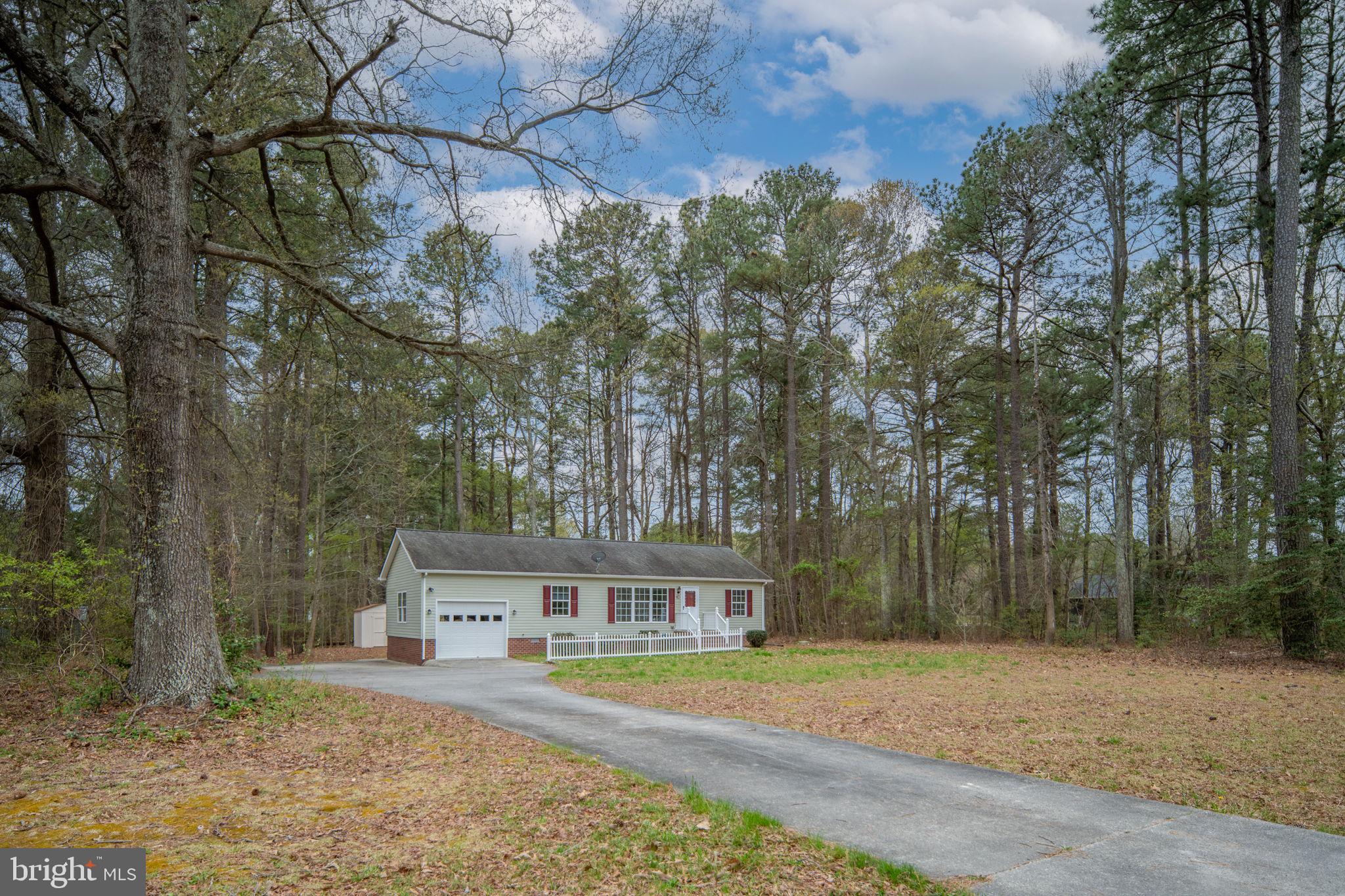 67 Stern Way Montross, VA 22520 - Photo 7 of 74 a front view of a house with a yard and trees