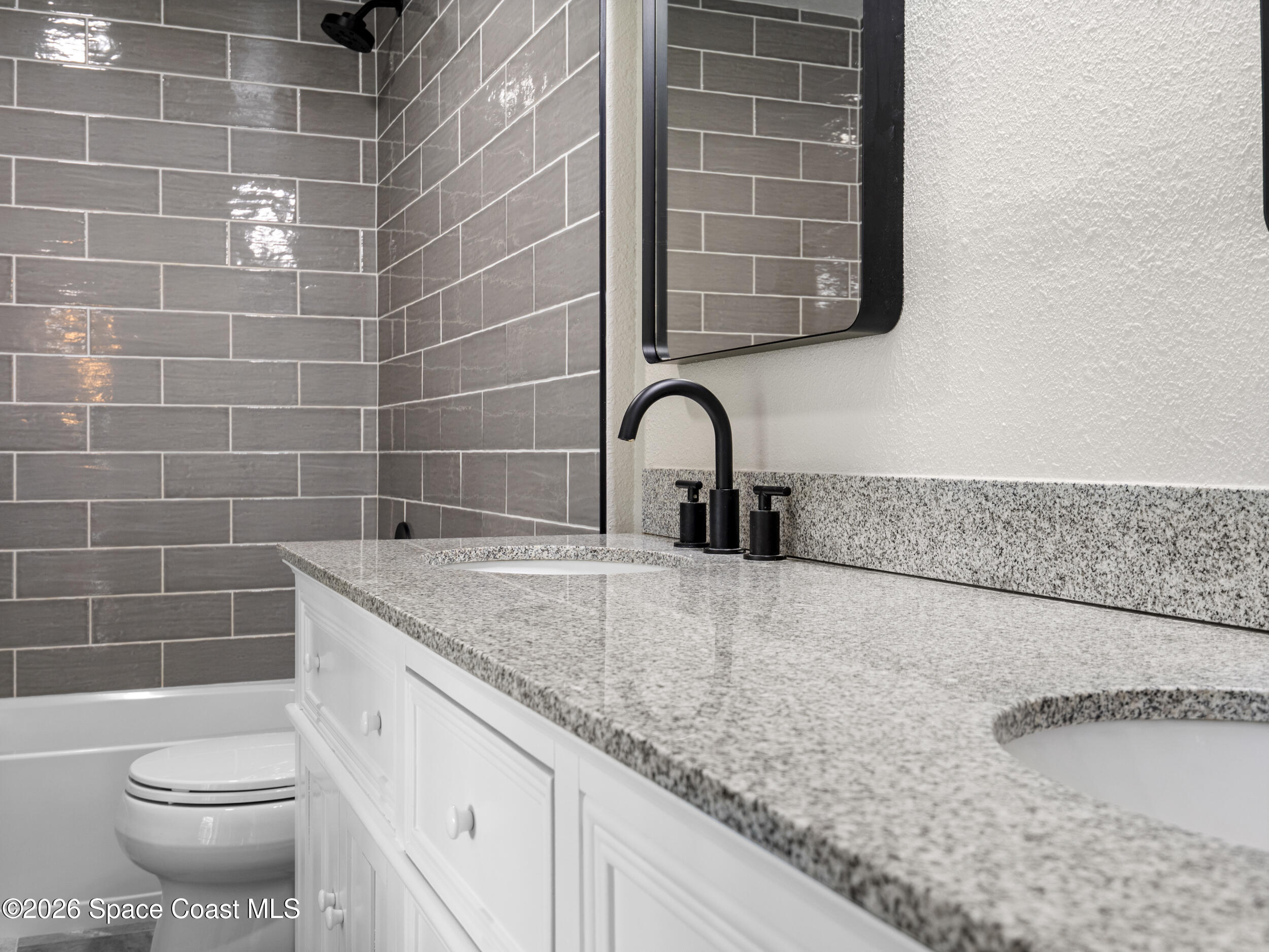 3480 Weber Road Malabar, FL 32950 - Photo 17 of 45 a bathroom with a granite countertop bathtub sink and toilet