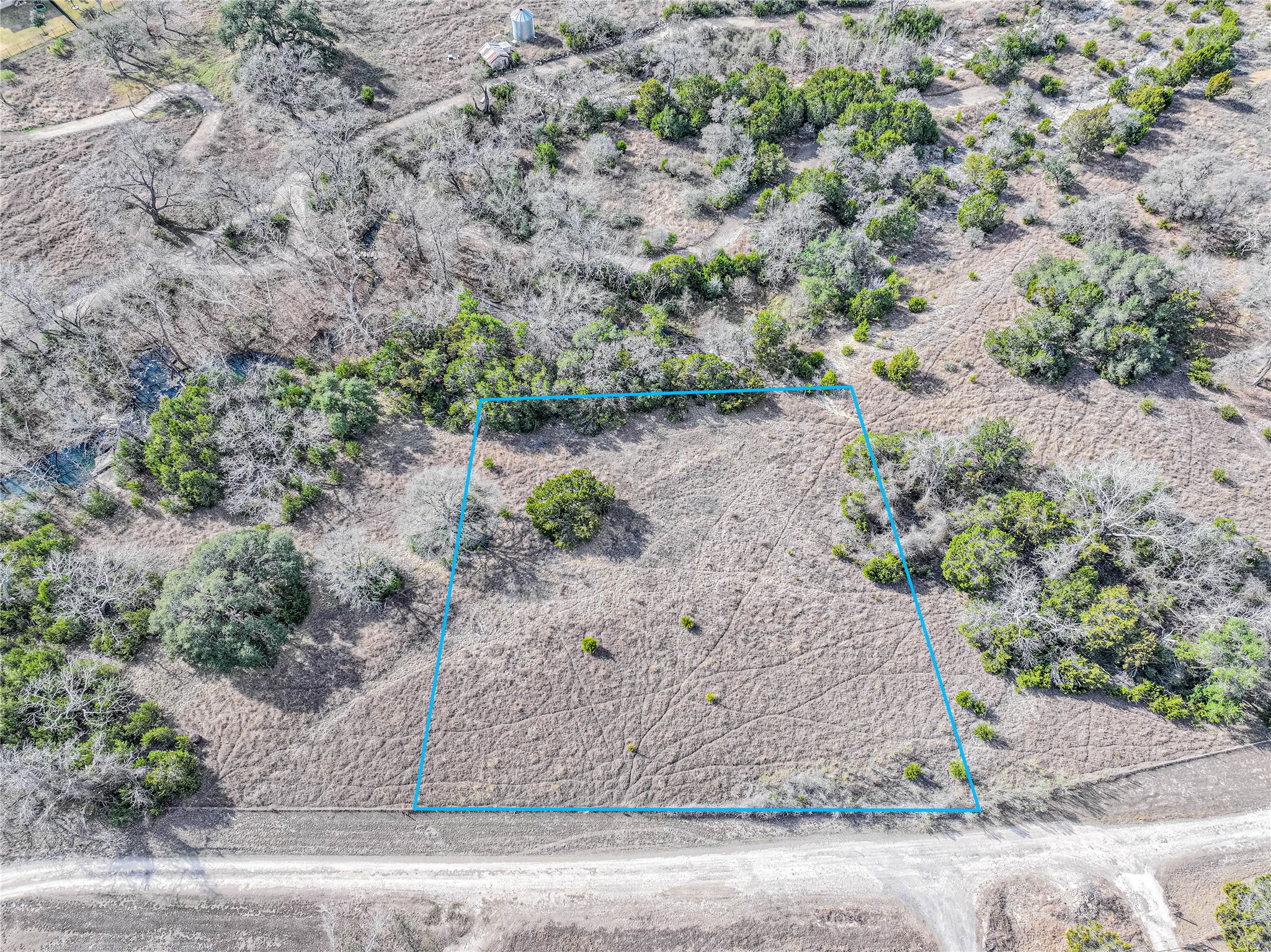 Aerial view of sparsely populated area with property boundaries highlighted