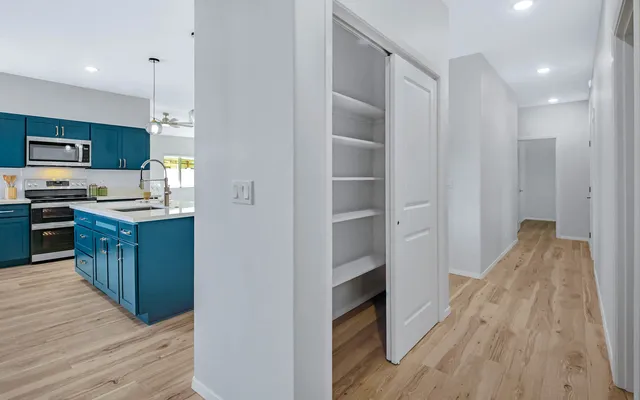a kitchen with kitchen island sink stove and refrigerator