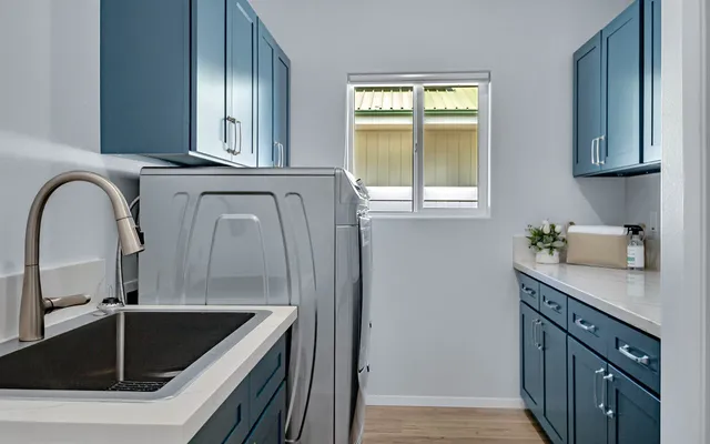a kitchen with a sink and a stove top oven