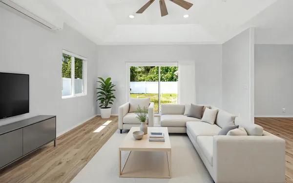 a living room with furniture a window and a flat screen tv