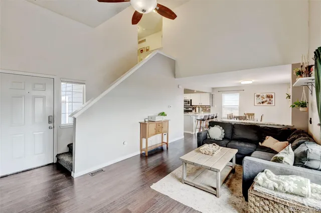 a living room with furniture and a wooden floor