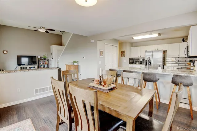 a dining room with furniture and wooden floor