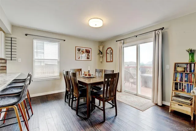 a view of a dining room with furniture and a bookshelf