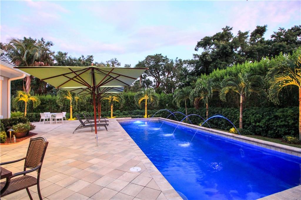 14 Middle Road Stuart, FL 34996 - Photo 7 of 33 a view of a swimming pool with lounge chairs