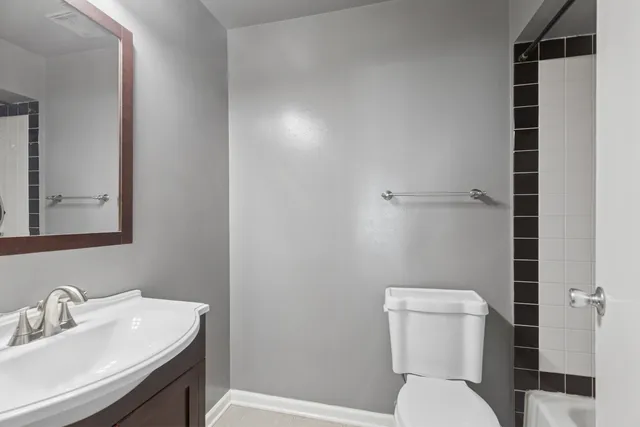 a bathroom with a toilet sink and shower