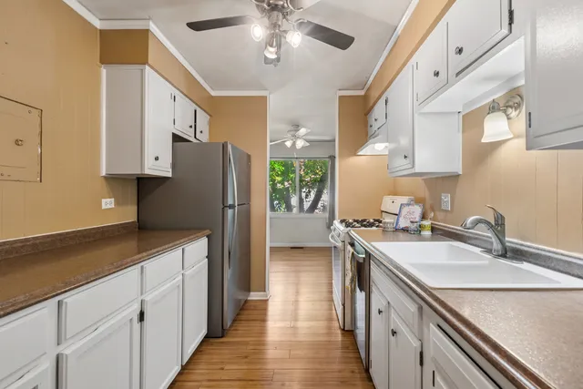 a kitchen with a sink stove and refrigerator