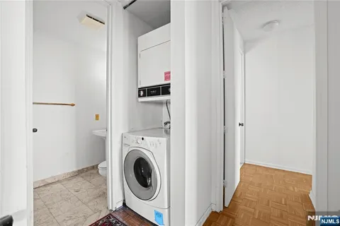a view of a hallway with washer and dryer