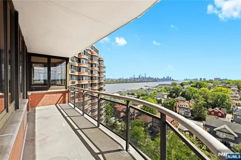 a balcony with wooden floor and outdoor seating