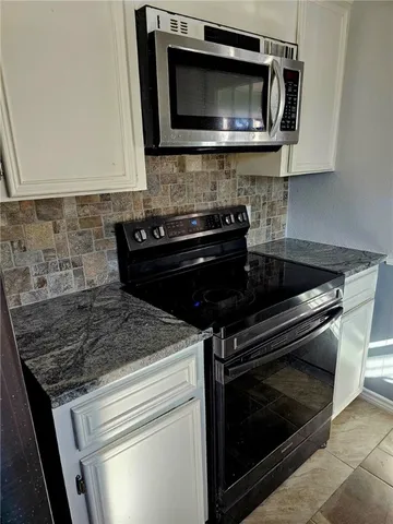 a kitchen with a stove and a microwave