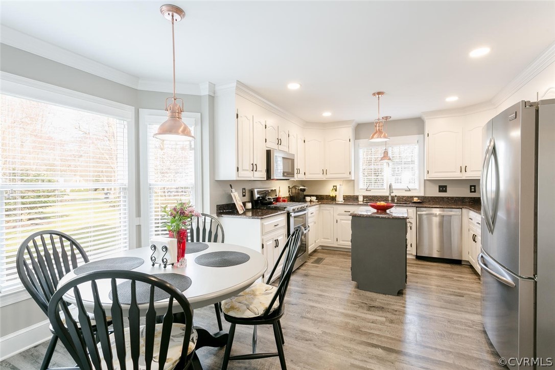403 Rivers Bend Court Chester, VA 23836 - Photo 14 of 39 a kitchen with stainless steel appliances granite countertop a dining table chairs stove refrigerator and cabinets