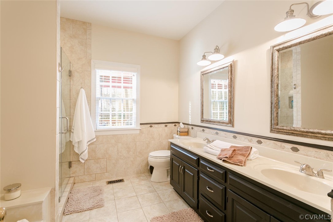 403 Rivers Bend Court Chester, VA 23836 - Photo 22 of 39 a bathroom with a sink mirror and a bathtub