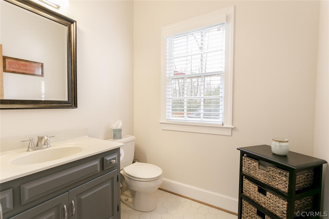 403 Rivers Bend Court Chester, VA 23836 - Photo 24 of 39 a bathroom with a toilet a sink a mirror and a window