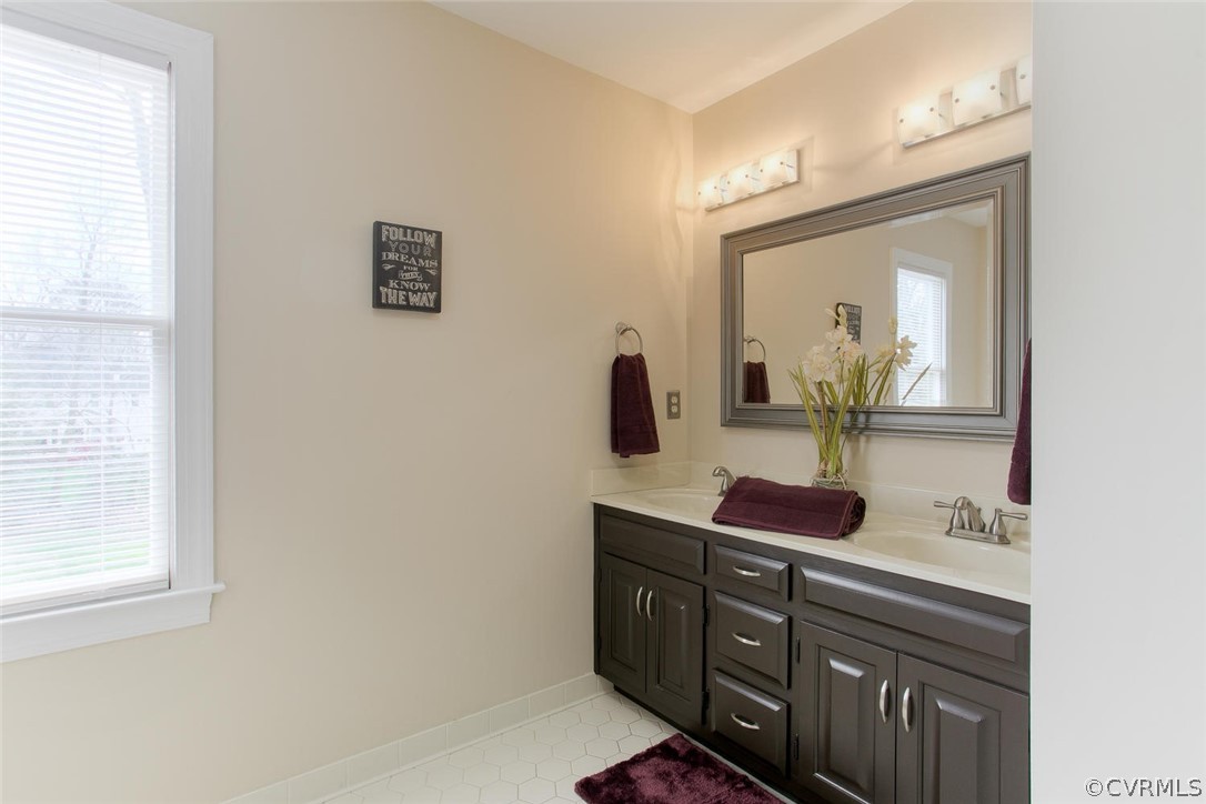 403 Rivers Bend Court Chester, VA 23836 - Photo 26 of 39 a bathroom with a sink and a mirror