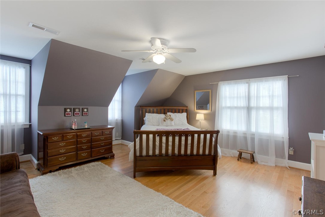 403 Rivers Bend Court Chester, VA 23836 - Photo 27 of 39 a spacious bedroom with a bed and a chandelier