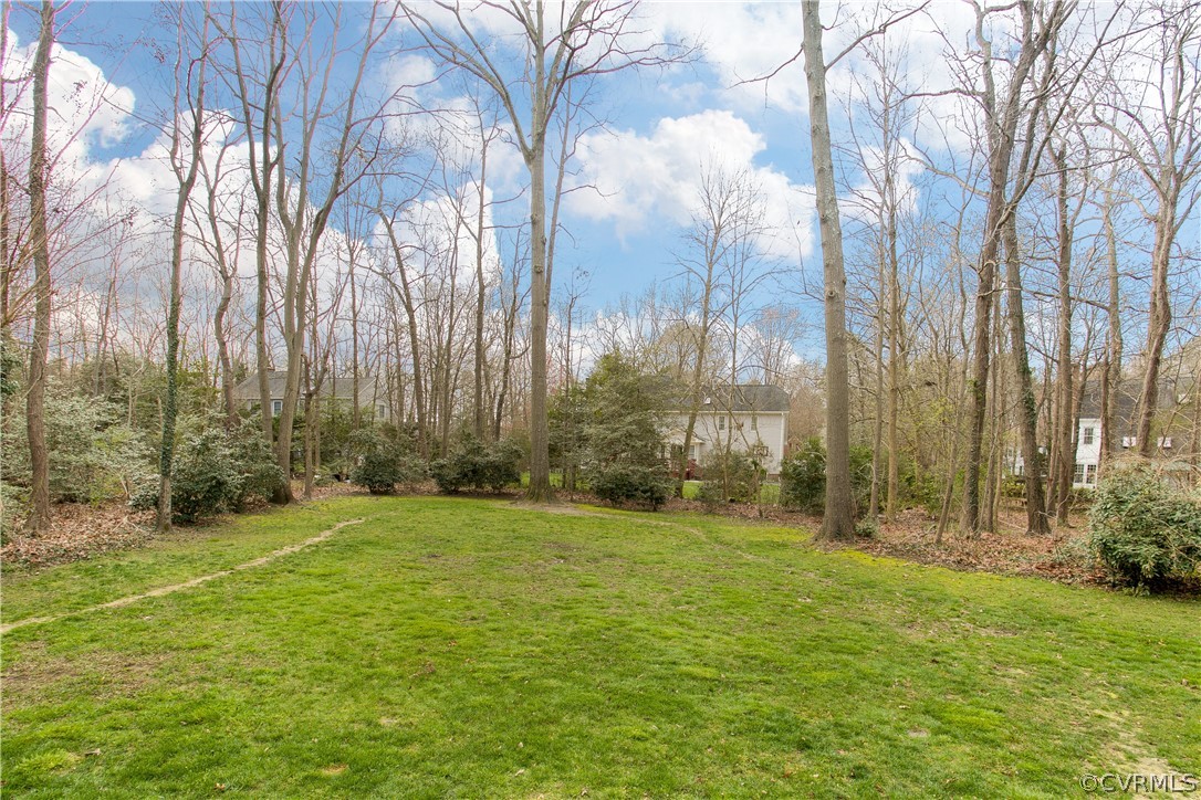 403 Rivers Bend Court Chester, VA 23836 - Photo 39 of 39 a backyard of apartments with large trees