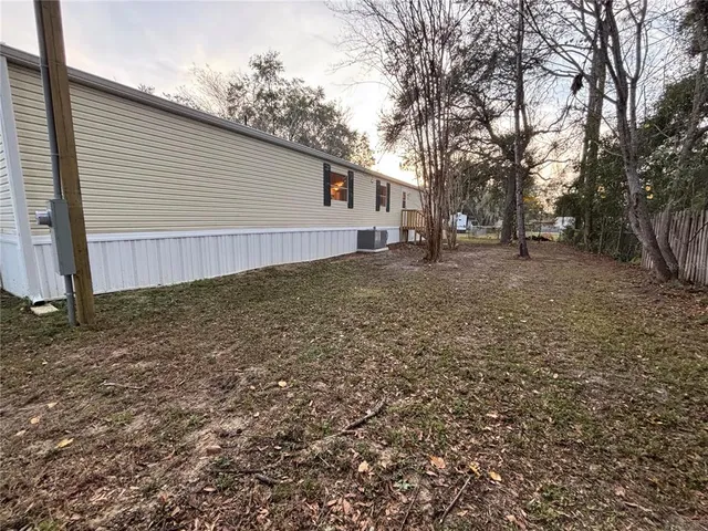 a view of a backyard with large trees
