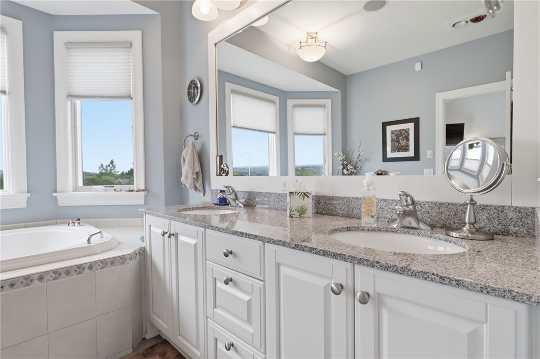 4536 Crystal Ridge Circle Gorham, NY 14424 - Photo 21 of 48 This stunning bathroom features an elegant double vanity complete with a premium granite countertop, providing both sophisticated style and ample space for daily routines.