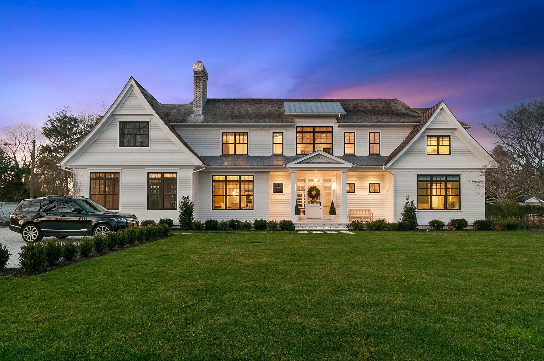 107 Wickapogue Road Southampton, NY 11968 - Photo 1 of 18 a front view of a house with a garden
