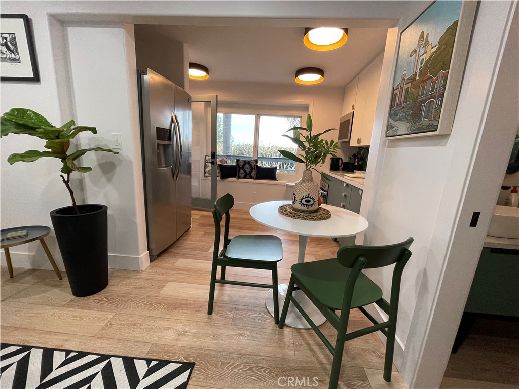 a view of a dining room with furniture and a potted plant