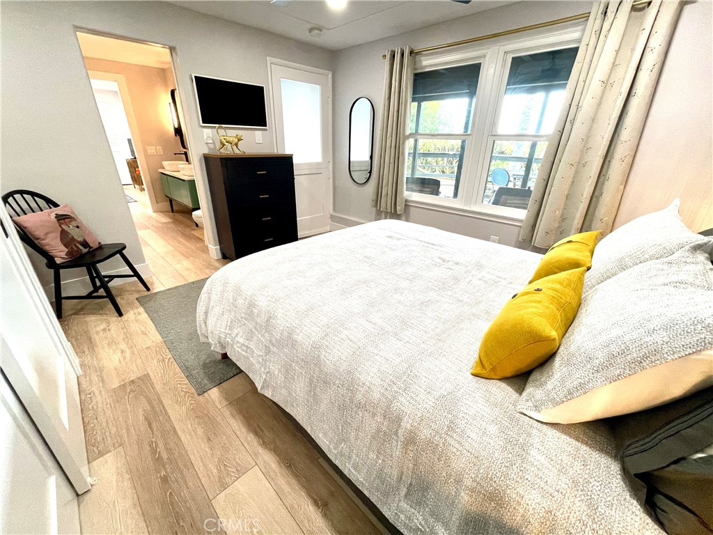 736 Griffith Place Laguna Beach, CA 92651 - Photo 18 of 31 a bedroom with a bed and a flat tv screen on the dresser