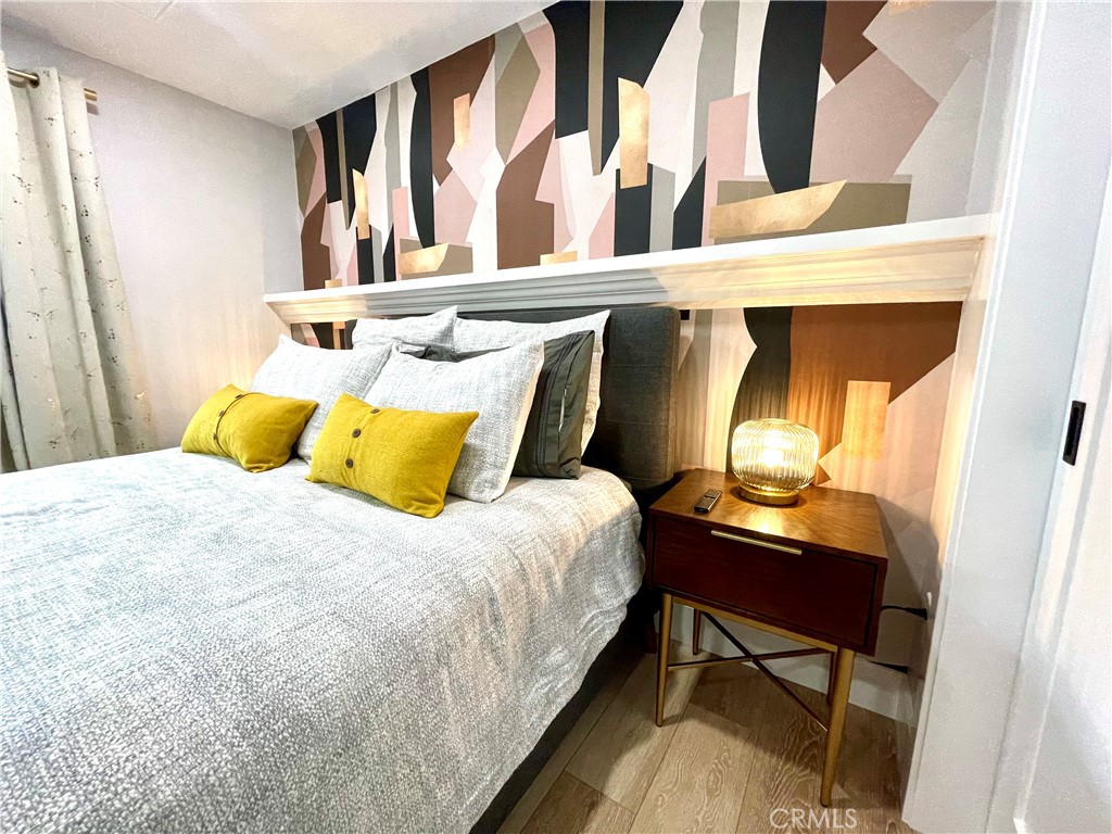 736 Griffith Place Laguna Beach, CA 92651 - Photo 19 of 31 a bedroom with a bed and wooden floor