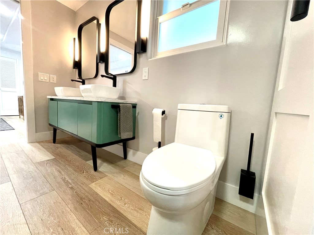 736 Griffith Place Laguna Beach, CA 92651 - Photo 28 of 31 a bathroom with a toilet sink and mirror