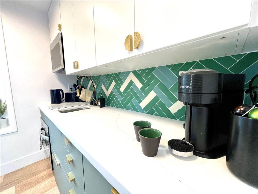 736 Griffith Place Laguna Beach, CA 92651 - Photo 9 of 31 a kitchen with a sink and a refrigerator
