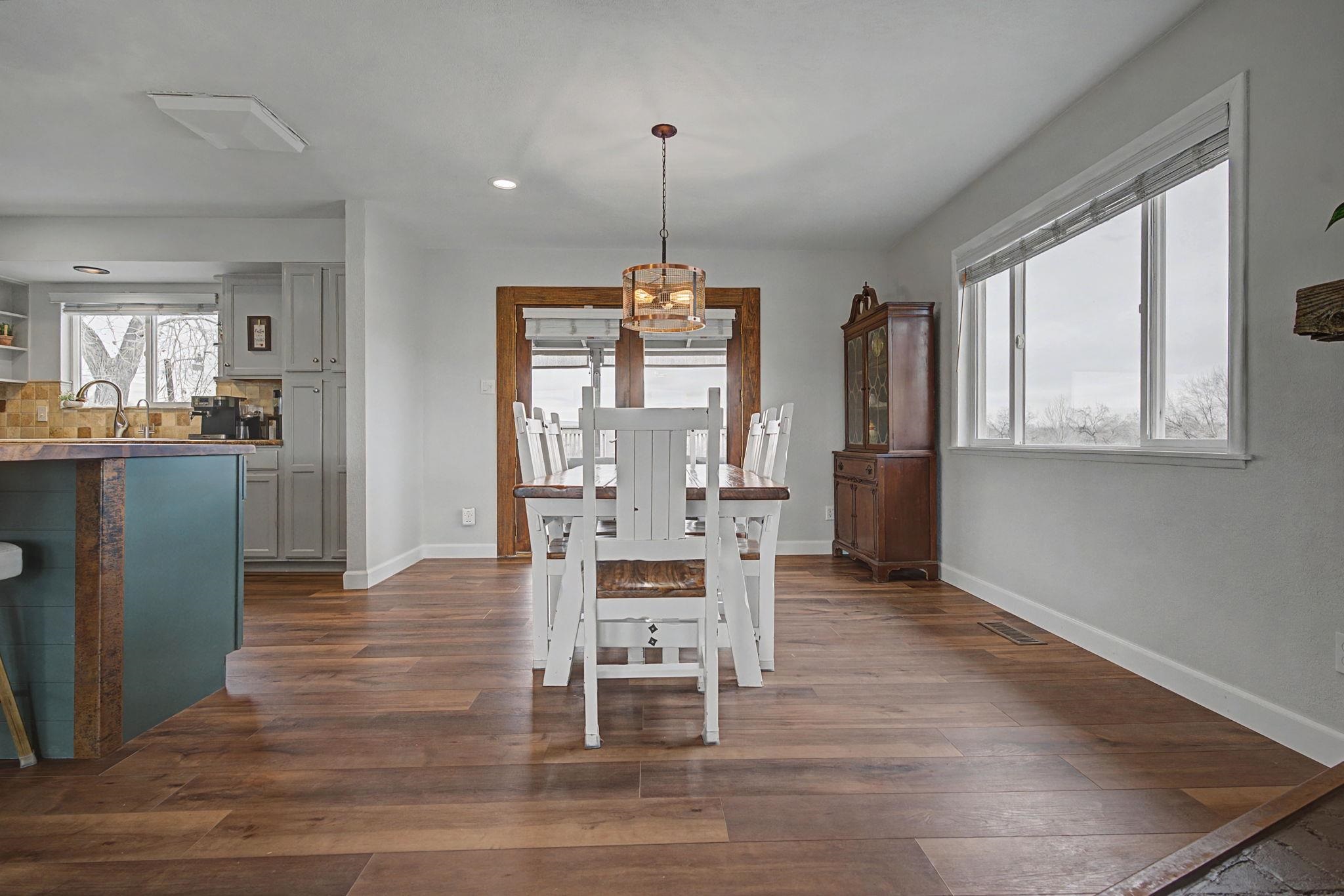 847 26 Road Grand Junction, CO 81505 - Photo 12 of 41 a dining room with furniture a chandelier and wooden floor