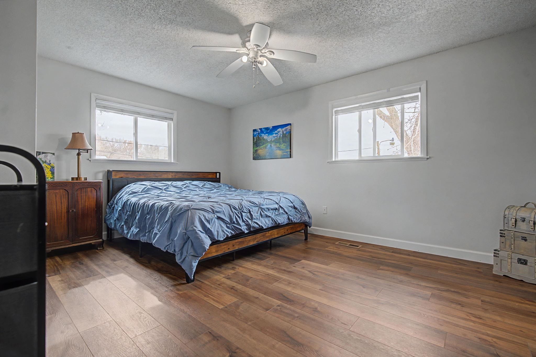 847 26 Road Grand Junction, CO 81505 - Photo 14 of 41 a bedroom with a bed and a dresser with wooden floor