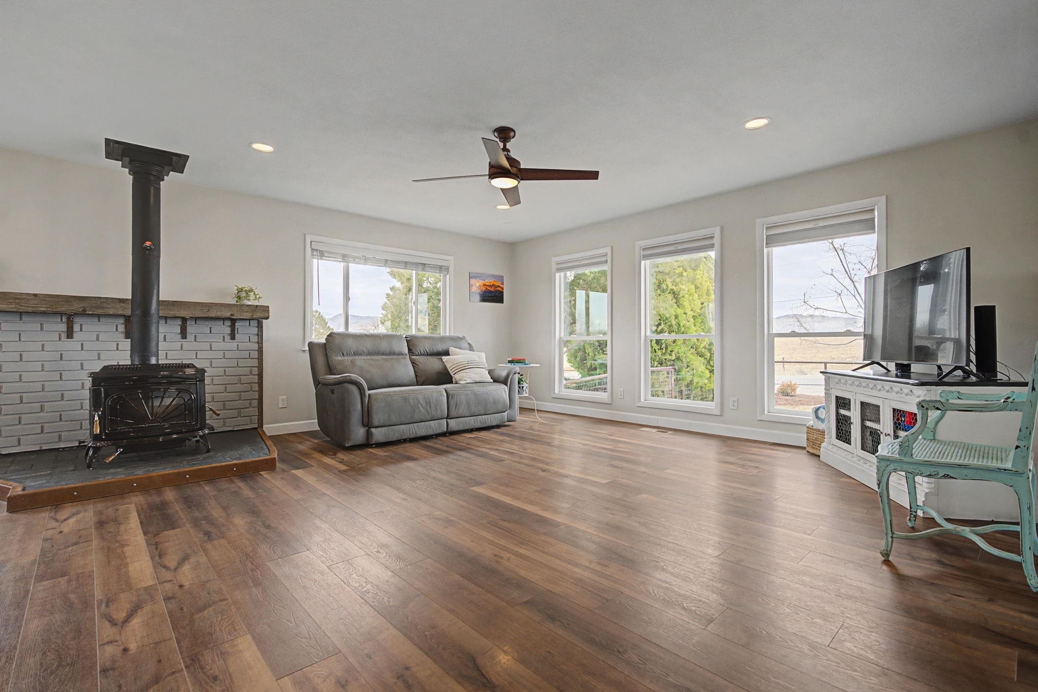847 26 Road Grand Junction, CO 81505 - Photo 4 of 41 a living room with furniture a fireplace and a flat screen tv
