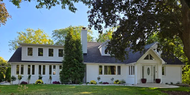 a front view of a house with a garden and yard
