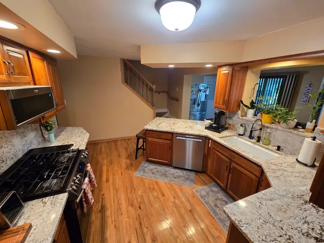 a kitchen with a sink appliances and cabinets