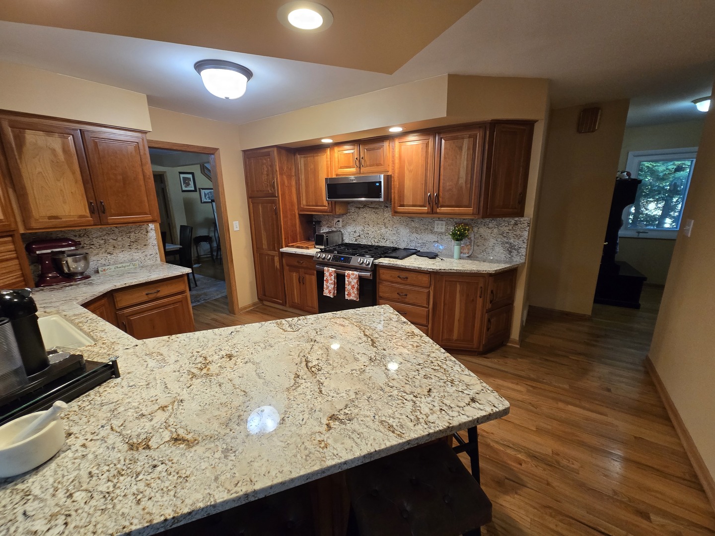 25W201 Summit Drive Naperville, IL 60563 - Photo 14 of 40 a kitchen with stainless steel appliances granite countertop wooden cabinets a stove top oven a sink and dishwasher