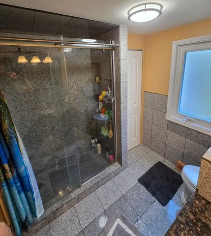a bathroom with a glass shower door