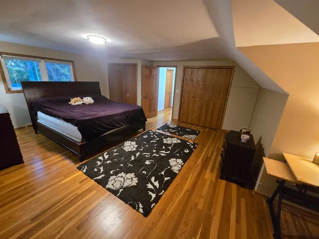 a bed sitting in a bedroom next to a window