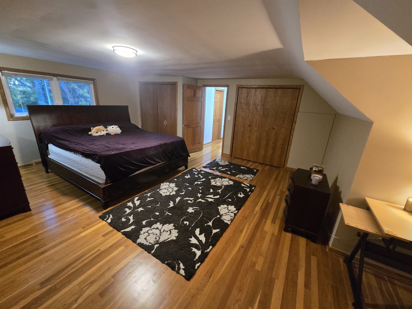 25W201 Summit Drive Naperville, IL 60563 - Photo 19 of 40 a bed sitting in a bedroom next to a window