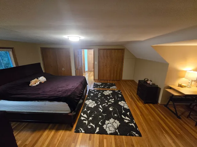 a bed sitting in a room next to a window