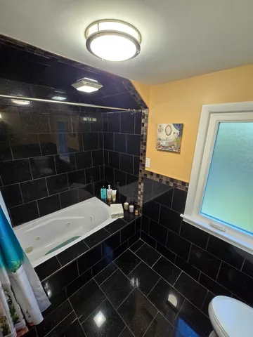 a bathroom with a sink a toilet and a shower