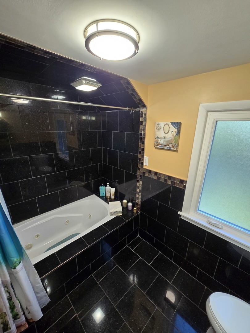 25W201 Summit Drive Naperville, IL 60563 - Photo 23 of 40 a bathroom with a sink a toilet and a shower