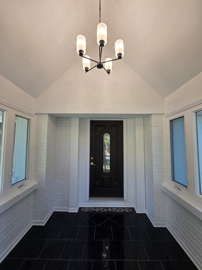 25W201 Summit Drive Naperville, IL 60563 - Photo 7 of 40 a view of a hallway with wooden floor and a cabinet