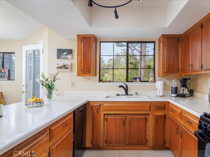 1912 Chester Lane Cambria, CA 93428 - Photo 14 of 41 a kitchen with a sink a window and cabinets